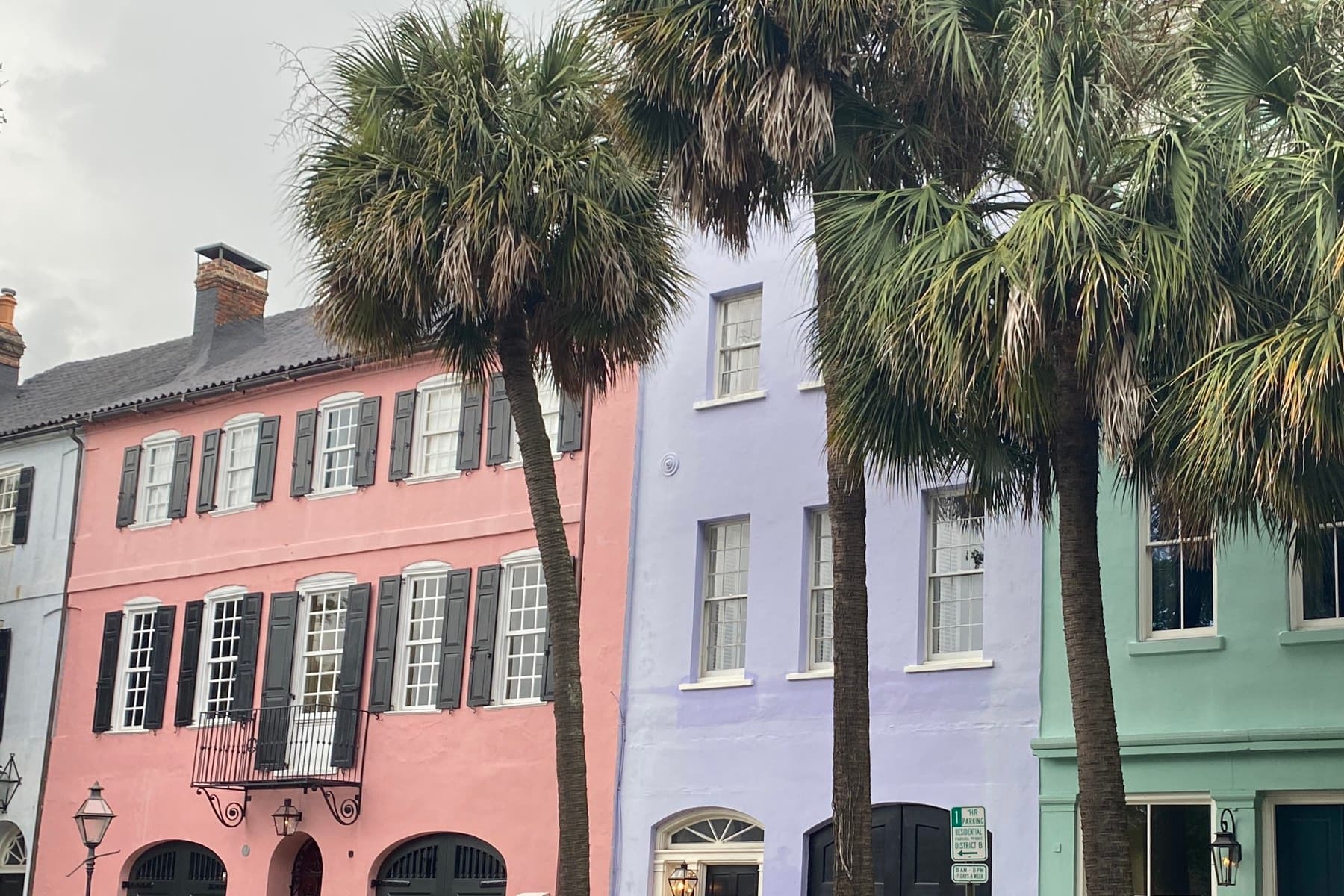 Rainbow Row houses in Charleston, South Carolina, framed by palmetto trees